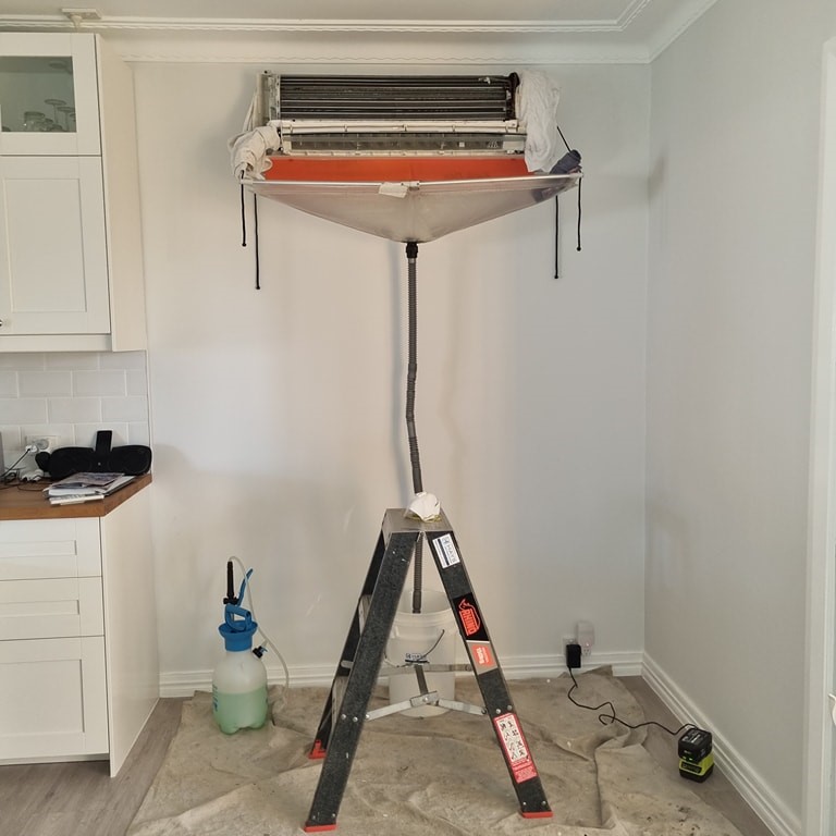 Professional air conditioner cleaning in progress