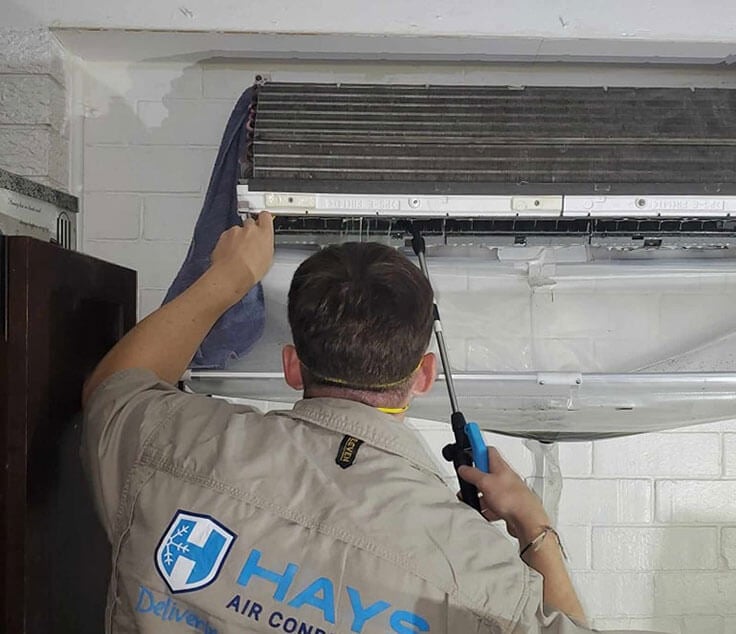 Close-up of an air conditioner being cleaned to remove dust and mould